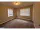 Bright bedroom with carpet, two windows, and neutral walls at 1643 Columbia Dr, Decatur, GA 30032