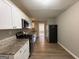 Galley kitchen with white cabinets, granite countertops, and stainless steel appliances at 1643 Columbia Dr, Decatur, GA 30032