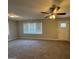 Spacious living room with neutral carpet, ceiling fan and plenty of natural light at 1643 Columbia Dr, Decatur, GA 30032
