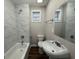 Bathroom with modern fixtures, white tile, and natural lighting at 192 Margaret St, Fairburn, GA 30213