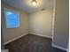 Neutral bedroom featuring carpeted floors and natural light from one window at 192 Margaret St, Fairburn, GA 30213