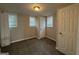 Neutral bedroom features carpeted floors, neutral walls, and natural light from two windows at 192 Margaret St, Fairburn, GA 30213