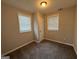 Neutral bedroom featuring carpeted floors and natural light from two windows at 192 Margaret St, Fairburn, GA 30213
