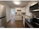 Galley kitchen featuring stainless steel appliances, granite countertops, and white shaker-style cabinets at 192 Margaret St, Fairburn, GA 30213