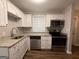 Kitchen boasts stainless steel appliances, granite countertops, and white shaker-style cabinets at 192 Margaret St, Fairburn, GA 30213