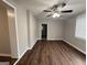 An empty living room with newly installed vinyl flooring and a modern ceiling fan at 192 Margaret St, Fairburn, GA 30213