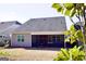 Home exterior featuring a screened-in back porch that overlooks the lawn at 2455 Westlington Cir, Cumming, GA 30040