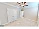 Bedroom with neutral walls and carpet with a closet, ceiling fan, and window at 2455 Westlington Cir, Cumming, GA 30040