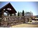 Stone monument sign for Mountain Crest community with covered entryway and landscaped flower beds at 2455 Westlington Cir, Cumming, GA 30040