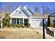 Beautiful home exterior with a craftsman-style garage door, well-kept lawn, and appealing landscaping at 2455 Westlington Cir, Cumming, GA 30040