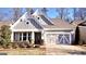 Charming home with a two-car garage, well-manicured lawn and attractive contrasting white and gray trim at 2455 Westlington Cir, Cumming, GA 30040