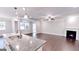 Open-concept space with a kitchen island overlooking the living area, featuring a fireplace and hardwood floors at 2455 Westlington Cir, Cumming, GA 30040