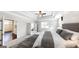 Luxurious main bedroom with a plush bed, tray ceiling, and adjoining sitting area at 2455 Westlington Cir, Cumming, GA 30040