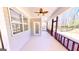 An empty screened in porch with paneled walls and views of the surrounding woods at 2455 Westlington Cir, Cumming, GA 30040