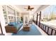 Bright sunroom with wicker furnishings, ceiling fan, and large windows offering serene views at 2455 Westlington Cir, Cumming, GA 30040