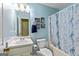 Well-lit bathroom featuring a vanity, toilet, and bathtub with a stylish shower curtain at 105. Meadow Springs Ct, Locust Grove, GA 30248