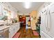 A well-lit kitchen with white cabinets and a view to the dining area at 105. Meadow Springs Ct, Locust Grove, GA 30248