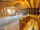 Unfinished attic with wooden beams, lighting, and storage shelves ready to be converted at 127 Circle H Rd, Sharpsburg, GA 30277