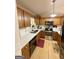 Well-lit kitchen featuring wood cabinets, stainless steel appliances, ample counter space, and wood-look flooring at 127 Circle H Rd, Sharpsburg, GA 30277