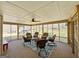 Spacious screened-in porch with seating area and ceiling fan provides outdoor living at 127 Circle H Rd, Sharpsburg, GA 30277