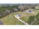 Aerial view showcases the home's exterior with a long driveway and the expansive surrounding land at 196 Old Highway 92, Fayetteville, GA 30215