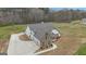 An aerial view showcasing the home's roof, stone exterior, and multiple garage doors with manicured landscaping at 196 Old Highway 92, Fayetteville, GA 30215