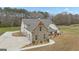 Aerial view of home with stone and white siding, three car garage, and long driveway at 196 Old Highway 92, Fayetteville, GA 30215