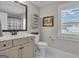 Bright bathroom featuring a vanity with quartz countertops, tiled floors, and plantation shutters at 196 Old Highway 92, Fayetteville, GA 30215