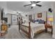 Carpeted bedroom featuring a four-poster bed, ceiling fan and plenty of natural light at 196 Old Highway 92, Fayetteville, GA 30215