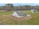 Back exterior of the home featuring a covered patio with outdoor seating and a spacious yard at 196 Old Highway 92, Fayetteville, GA 30215