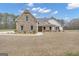 Charming home featuring stone accents, a covered porch, and beautifully landscaped front yard at 196 Old Highway 92, Fayetteville, GA 30215