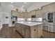 A modern kitchen features a large island, stainless steel appliances, and stylish cabinetry at 196 Old Highway 92, Fayetteville, GA 30215