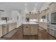 An open-concept kitchen boasts a large island, modern finishes, and stainless steel appliances at 196 Old Highway 92, Fayetteville, GA 30215
