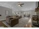 Bright living room with a brown leather couch, light colored area rug, and two chairs by the windows at 196 Old Highway 92, Fayetteville, GA 30215