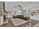 Spacious living room with a large brown leather couch, stone fireplace, and hardwood floors at 196 Old Highway 92, Fayetteville, GA 30215