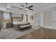 Main bedroom showcasing a trey ceiling, large bed, windows, and hardwood floors at 196 Old Highway 92, Fayetteville, GA 30215