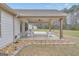 Inviting covered patio with a ceiling fan and comfortable seating, nestled in a serene setting with a view of the lush backyard at 196 Old Highway 92, Fayetteville, GA 30215