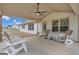 Wonderful covered patio with ceiling fan and ample seating for outdoor relaxation and entertaining, complete with a lush green lawn at 196 Old Highway 92, Fayetteville, GA 30215