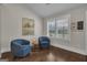 Cozy sitting area with two blue chairs by a bright window with shutter blinds at 196 Old Highway 92, Fayetteville, GA 30215