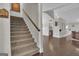 Carpeted staircase with wood handrail and access to the main floor and kitchen area at 196 Old Highway 92, Fayetteville, GA 30215