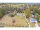 Drone angle showing surrounding homes, large yards, wooded areas, and sheds at 1312 Milstead Ne Ave, Conyers, GA 30012