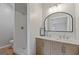 This bathroom features a double sink vanity and tiled shower at 1312 Milstead Ne Ave, Conyers, GA 30012