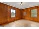 Bedroom featuring wood walls and hardwood flooring at 1312 Milstead Ne Ave, Conyers, GA 30012