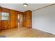 Bedroom featuring wood walls, hardwood flooring and white walls at 1312 Milstead Ne Ave, Conyers, GA 30012