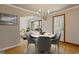 Dining area with stylish chandelier, hardwood floors, and a view into the cozy living area at 1312 Milstead Ne Ave, Conyers, GA 30012