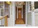 Inviting foyer featuring gleaming hardwood floors, natural light, and a classic wooden front door at 1312 Milstead Ne Ave, Conyers, GA 30012