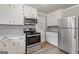 Modern kitchen features bright white cabinets, stainless steel appliances, and ample counter space at 1312 Milstead Ne Ave, Conyers, GA 30012