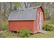 Red storage shed nestled among greenery, offering practical outdoor storage space at 1312 Milstead Ne Ave, Conyers, GA 30012