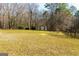 Expansive backyard featuring mature trees, a lush lawn, and a storage shed at 260 Brookwood Ln, Fayetteville, GA 30215