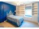 Cozy bedroom with built-in bookshelves and window seat, all bathed in natural light at 260 Brookwood Ln, Fayetteville, GA 30215